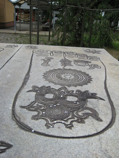 an der Seite der Statue sind zwei riesige Füße in eine Platte gemeißelt, und scheinbar werfen die Leute Geld da hinein...