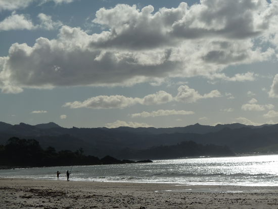 Coromandel in der Daemmerung. Kiwis beim Angeln