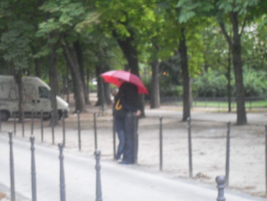 Ein Pärchen, das sich unterm Regenschirm küsst