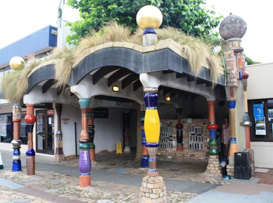 die Hundertwassertoilette in Kawakawa von aussen (in der Mitte steht ein Baum!)