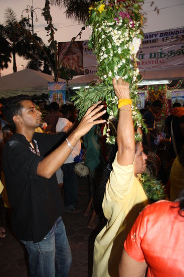 Hier eine Frau mit gelben Gewand und einem Gefäß voll Milch.
