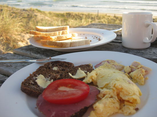besser geht ein fruehstueck nicht! ma beachte besonders das natur-ambiente im hintergrund: grasbewachsene duenen ud rauschende wellen, die morgens von uns aufgewuehlt wurden
