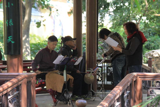 Musizierende Chinesen in einem kleinen Pavillon