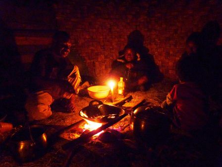 Bei gemütlichem Kerzenlicht wird das Abendessen über offenem Feuer zubereitet.