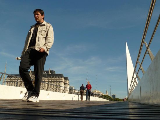 bad looking guy crossing a bridge