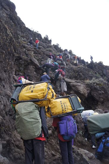 Die vor uns gestartete Ami-Truppe in der Felswand. Die Helfer tragen nicht nur das Gepäck. Auch einige der älteren Bergabenteurer werden über die schlimmsten Klippen gehievt.