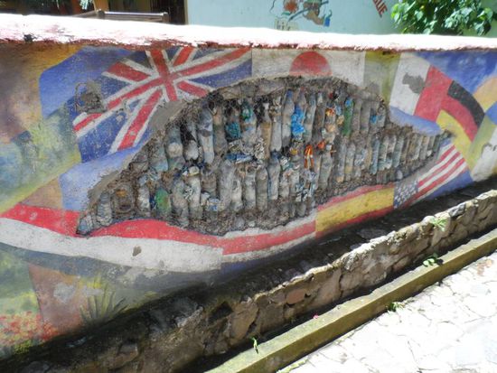 Super Idee - eine Wand aus alten Plastikflaschen die mit Muell gefuellt sind