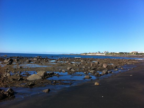 Felsformation am schwarzen Sandstrand