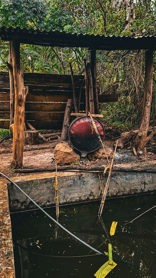 Eine interessante Distellerie—im Fass wird das Gemisch erhitzt—fließt über die Röhren aus Bambus und wird durch das kühle Flußwasser, welches hier gesammelt ist, gekühlt.
