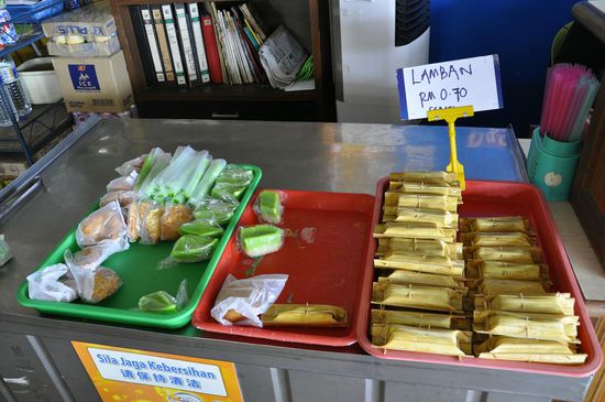 Das probieren wir auch alles: links sind süße Sachen.sowas wie Michreisstückchen und iwas mit Kokos--rechts in Bananenblättern etwas ähnliches wie Sushi