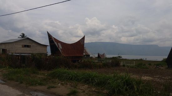 Etwas bescheidener: ein Haus mit Grab im Hintergrund