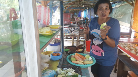 An der Straße reihen sich die Imbissbuden. Wir suchen eine auf..