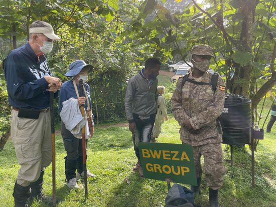 Während wir uns eine Tanzvorführung einheimischer Frauen anschauen und am Briefing teilnehmen, beobachten wir Arthur, wie er im Hintergrund die Fäden spinnt und eine gute Gruppe für uns aussucht. Wir gehören zur Gruppe „Bweza“. So heißt die Familie der Gorilla, die wir besuchen. Zu unserer Gruppe gehören 4 Schweizer sowie  Dorothy und Arthur aus South Carolina - sie sind stolze 77 Jahre alt! 
Wir heuern einen Porter an, der unseren Rucksack mit der Fotoausrüstung trägt und im Laufe des Trekking häufig eine helfende Hand reichte.