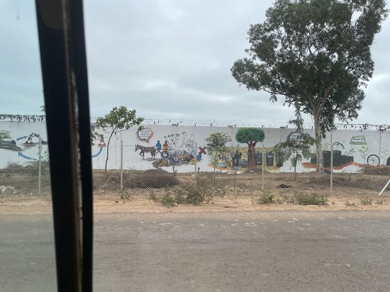 Ein Stück weiter sind die Gefängnismauern bemalt. Gegenüber befindet sich ein Camp für die Familien der Strafgefangenen