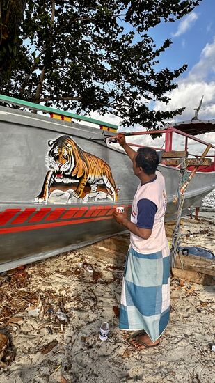 Drüben angekommen, tauchen wir in das abgeschiedene Inselleben mit seinen Bewohnern ein…er bemalt liebevoll sein Boot…